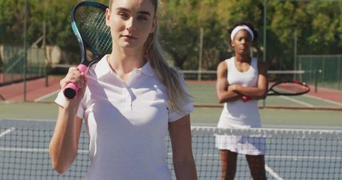 Focused Female Tennis Players on Outdoor Court Under Sunny Sky