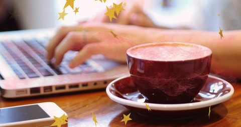 Freelancer enjoying coffee break typing in cozy café atmosphere