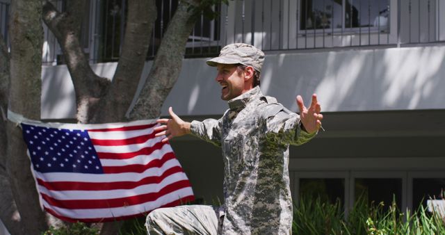 Soldier in military uniform embracing outdoors with a joyous expression near American flag and home background. Perfect for homecoming, patriotic events, military family reunions, and celebratory occasions showcasing love and honor for country.
