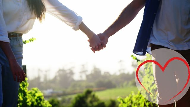 Couple holding hands in a picturesque park setting, enhanced with a heart animation symbolizing love and romance. Ideal for relationship and love-themed content, advertisements, wedding and Valentine’s Day promotions, and social media posts to show togetherness and affection.