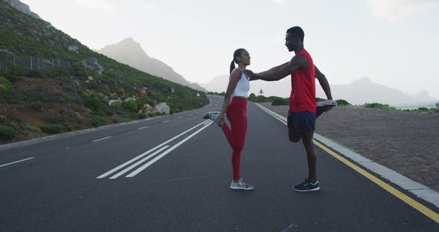 Young Couple Stretching on Scenic Road Before Workout - Download Free Stock Images Pikwizard.com