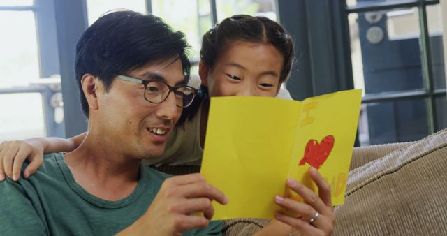 Happy Father and Daughter Reading Handmade Card at Home - Download Free Stock Images Pikwizard.com