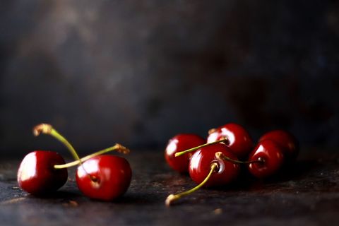 Fresh juicy cherries on rustic cherry background