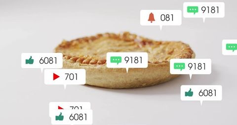 Golden tart sitting on white tabletop with floating social media like and comment bubbles