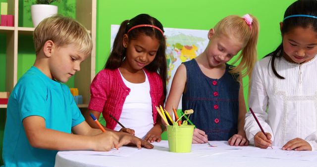 Happy Children Drawing Together at Classroom Table - Download Free Stock Images Pikwizard.com