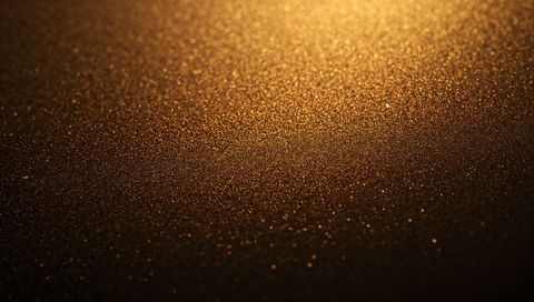 Shimmering Golden Glitter Macro Texture with Warm Bokeh Highlights for Luxury Backgrounds