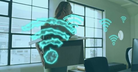 Mid-adult woman carrying moving box in bright urban office with holographic wi-fi network