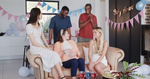 Multiracial Friends Enjoying Baby Shower Celebration Indoors