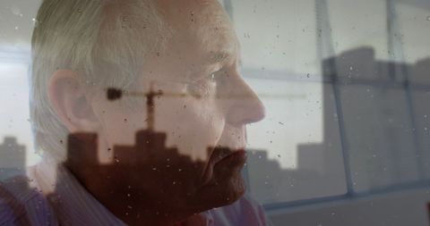 Reflective Senior Man with Urban Cityscape Overlay