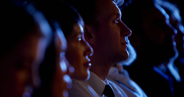 Focused Group of People Watching Presentation in Dimly Lit Room - Download Free Stock Images Pikwizard.com