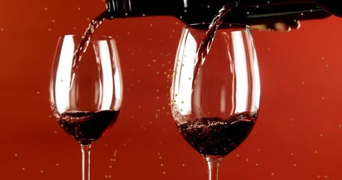 Red Wine Pouring into Glasses Against Red Background - Download Free Stock Images Pikwizard.com