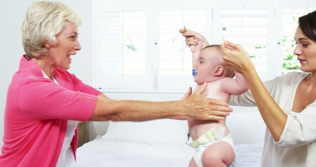 Three Generations of Family Playing with Baby at Home - Download Free Stock Images Pikwizard.com