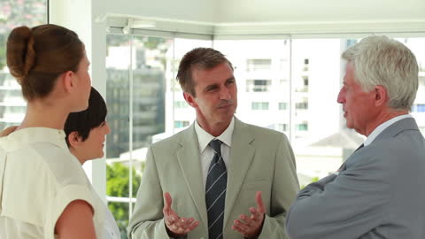 Business Professionals Engaging in Office Discussion