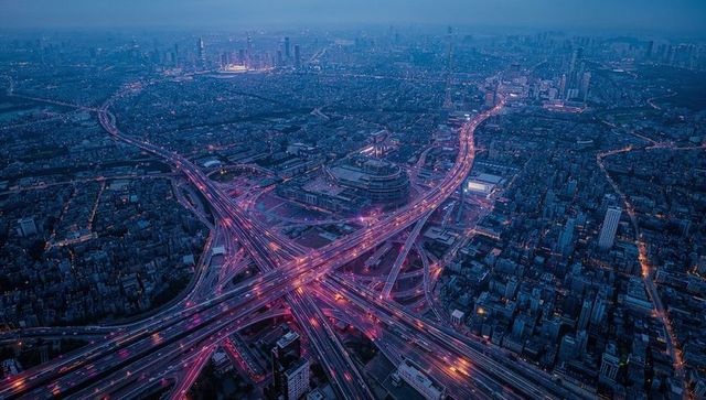Aerial View of City Interchange at Night with Light Trails