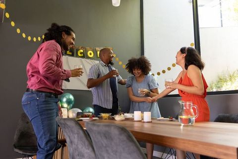 Diverse Friends Laughing Together at Home Celebration