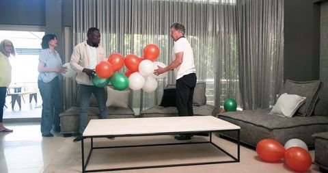 Diverse Group Tidying After Celebration in Rehabilitation Center