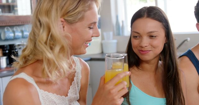 Friends Enjoying Morning Juice in Bright Kitchen - Download Free Stock Images Pikwizard.com