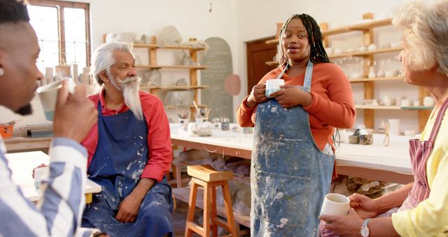 Diverse group enjoying pottery workshop with tea break - Download Free Stock Images Pikwizard.com