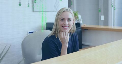 Smiling receptionist in modern office with digital code overlay