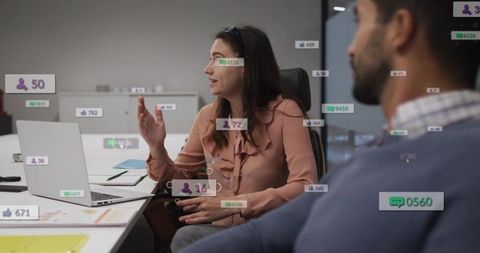 Businesswoman gesturing in boardroom during collaborative meeting with ar social overlays