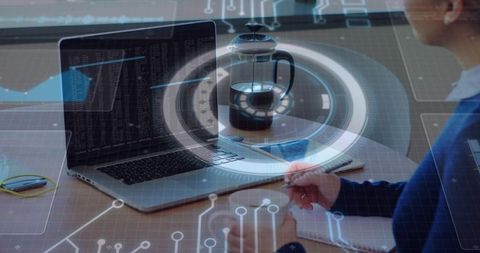 Remote coder writing notes at minimalist desk with laptop, notebook and cyber hud overlay