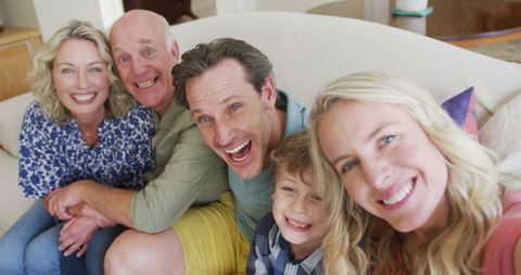 Joyful Multigenerational Family Taking Selfie in Living Room Setting