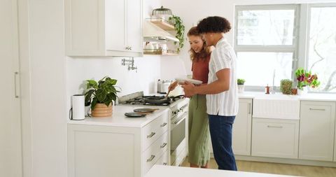 Couple Cooking Together in Bright Modern Kitchen