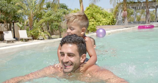 Father and son swimming together in outdoor pool, enjoying summer vacation - Download Free Stock Images Pikwizard.com