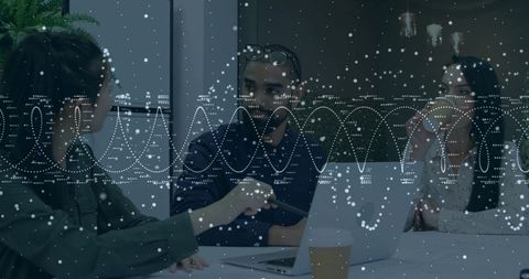 Team Collaborating over Laptop with Digital Data Overlay in Modern Office Meeting