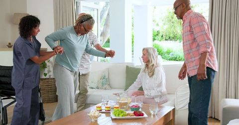 Senior friends supporting one another in a cozy living room
