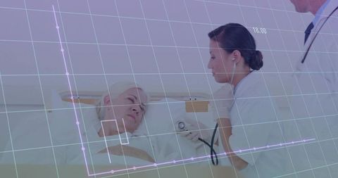 Caring Nurse Checking Blood Pressure of Senior Patient in Hospital Bed