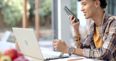 Young Entrepreneur Communicating with Smartphone in Modern Workspace