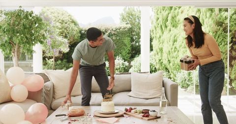 Cheerful Couple Preparing for Festive Birthday Celebration at Home