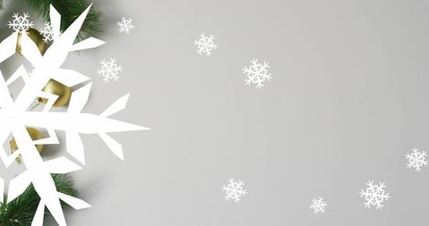 Elegant snowflake cutout with pine branches on gray