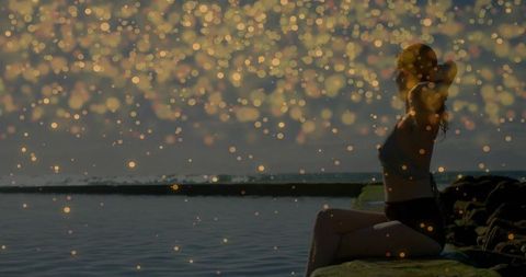 Tranquil Dawn Exercise by Water with Golden Bokeh Effects