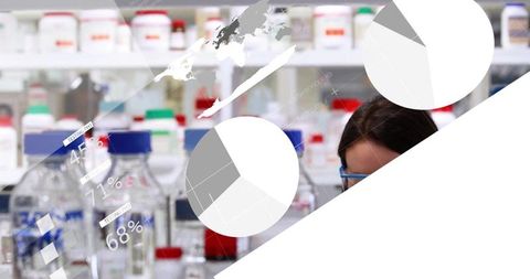 Scientist Analyzing Laboratory Data Among Reagent Bottles