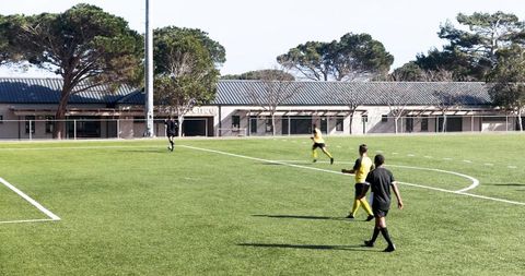 Soccer Players Practicing Teamwork on Sunlit Field