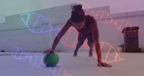 Woman exercising with medicine ball and dna overlays