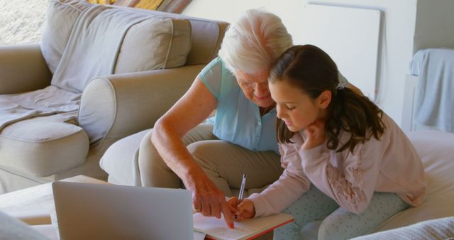 Grandmother Helping Granddaughter with Homework on Couch - Download Free Stock Images Pikwizard.com