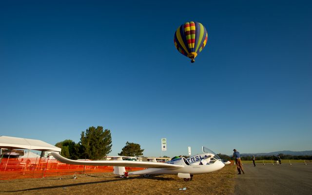 A hot air balloon passes over the campus of the 2011 Green Flight Challenge, sponsored by Google, at the Charles M. Schulz Sonoma County Airport in Santa Rosa, Calif. on Thursday, Sept. 29, 2011. NASA and the Comparative Aircraft Flight Efficiency (CAFE) Foundation are having the challenge with the goal to advance technologies in fuel efficiency and reduced emissions with cleaner renewable fuels and electric aircraft. Photo Credit: (NASA/Bill Ingalls)