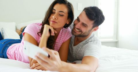 Happy Couple Relaxing and Taking Selfies in Bedroom - Download Free Stock Images Pikwizard.com