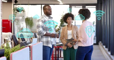 Team discussing cloud collaboration strategy using tablet in bright open-plan workspace