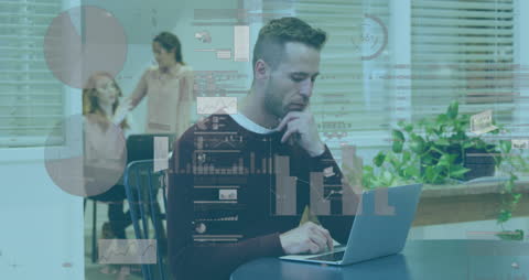 Businessman Engaged with Laptop Analyzing Data in Modern Office