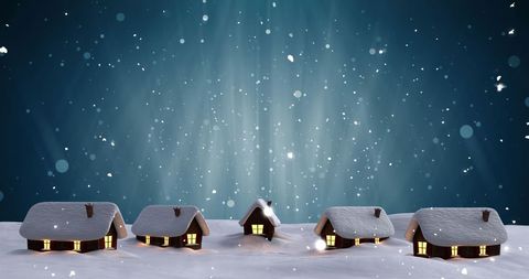Winter Village Under Snowfall with Lit Houses