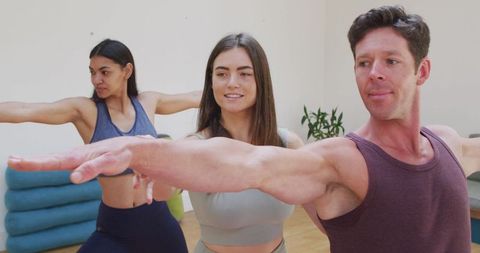 Diverse Group Practicing Yoga with Female Instructor