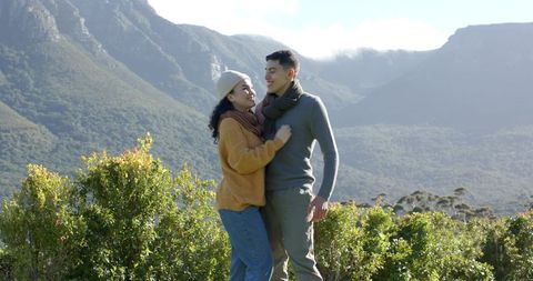 Couple Embracing in Scenic Mountain Valley