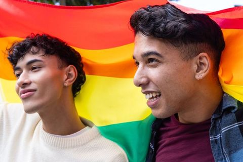 Two Friends Celebrating LGBTQ Pride with Rainbow Flag