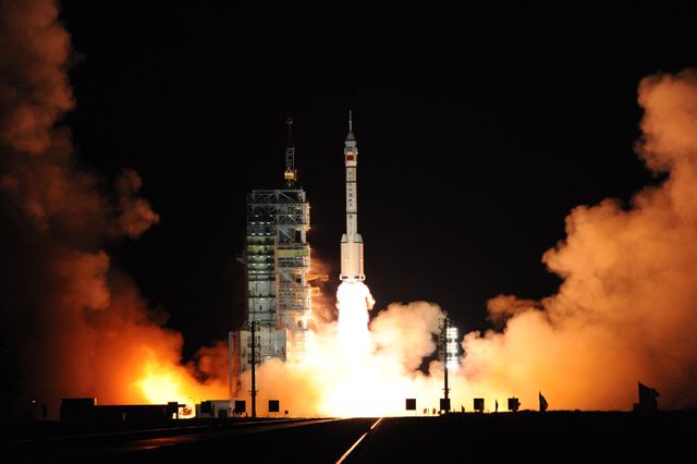 Nighttime rocket launch with fiery engines and illuminated sky - Download Free Stock Photos Pikwizard.com