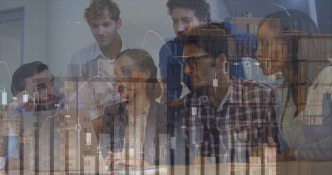Multicultural business team analyzing financial graphs in modern office