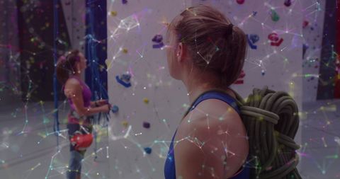 Two Women Indoor Rock Climbing with Digital Tech Overlay